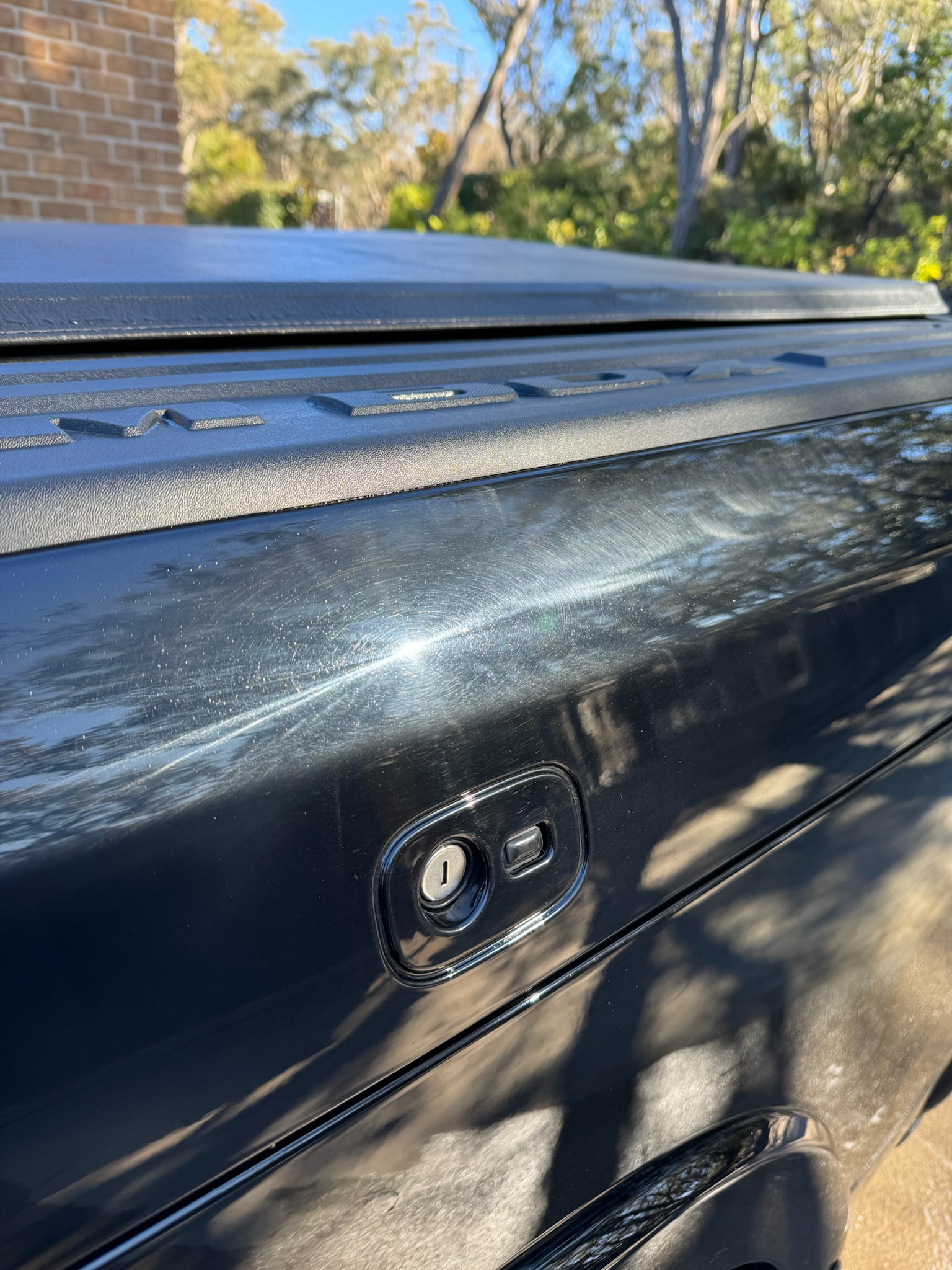 Before: scratches on black ute tailgate